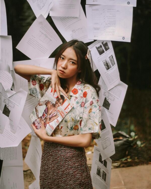 Woman Holding Magazine Close-up Photography